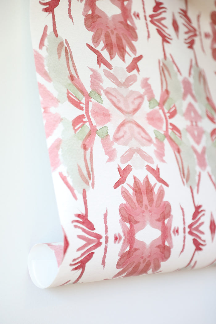Luxury floral wallpaper featuring an artistic wildflower pattern in strawberry pink, blush, and soft green tones, designed for modern traditional interiors, bedrooms, powder rooms, and collected homes.